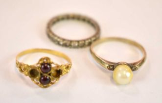 A 9ct yellow gold pearl set ring, size P, an eternity ring, and a garnet set yellow metal ring (