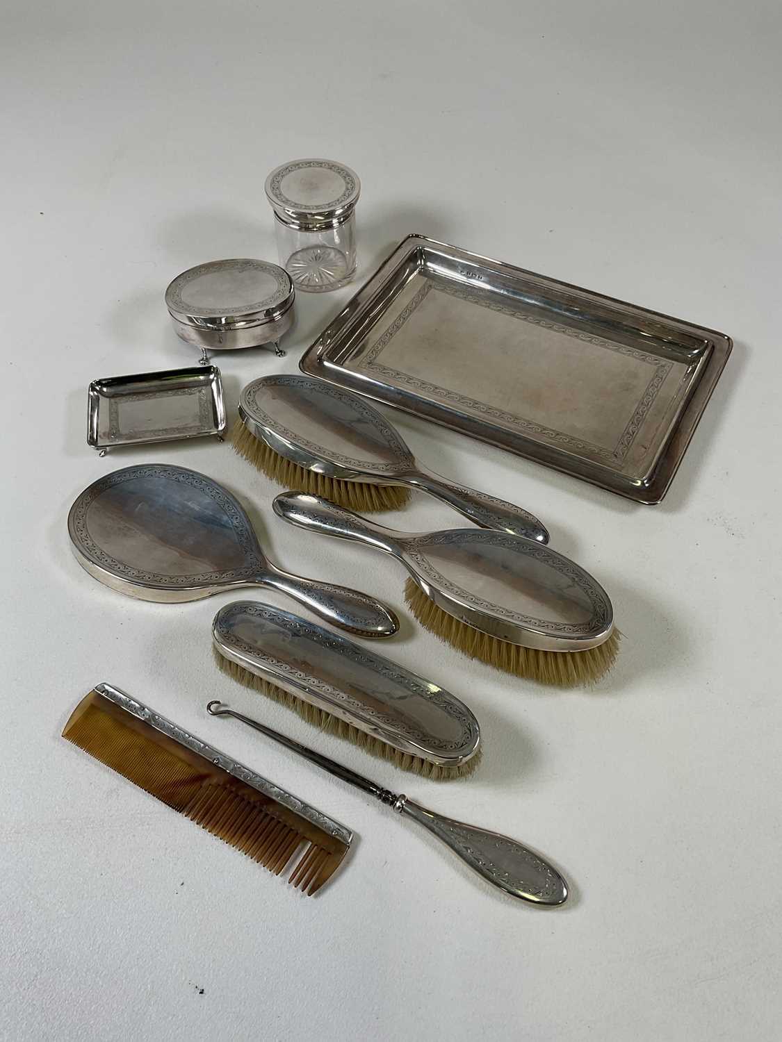 A George V hallmarked silver ten piece dressing table set comprising tray, small pin dish, jewellery