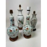 A pair of Chinese floral decorated lamp bases, height 29cm, and two further Chinese inspired