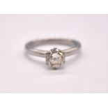 A platinum and diamond solitaire ring, the round brilliant cut six claw set stone weighing approx.