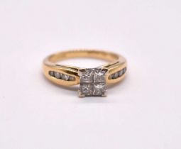 An 18ct yellow gold diamond cluster ring, the raised central platform set with four princess cut