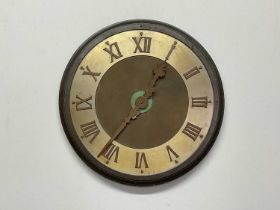 A 20th century large wall clock constructed of steel and brass with raised Roman numerals to the