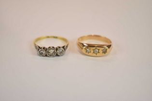 A yellow metal three stone diamond ring, size P, and an 18ct yellow gold platinum tipped three stone