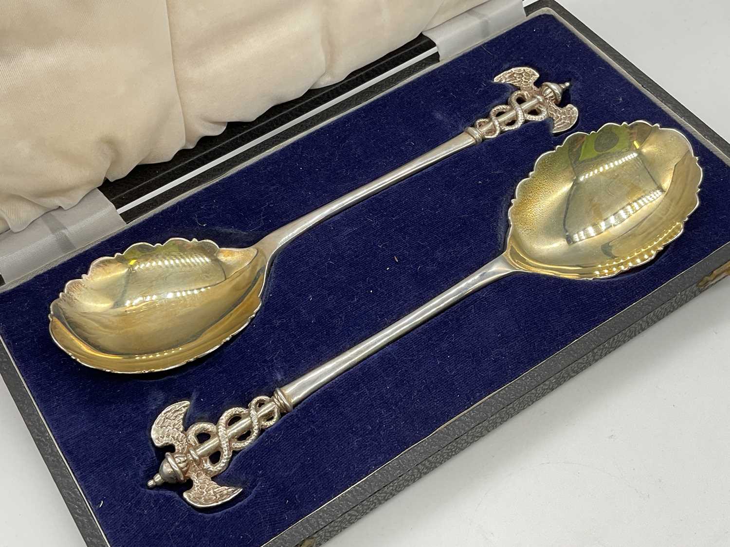 JAMES DEAKIN & SONS; a cased pair of George V hallmarked silver spoons with finials modelled as - Image 2 of 2