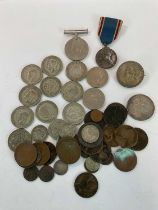 A small group of coins, including a George V 1822 crown, a United States $1 formed now as a