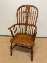 A 19th century hoop back Windsor elbow chair with ash and elm frame, saddle seat, and ring turned