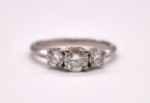 An 18ct white gold diamond three stone ring set with graduated round brilliant cut claw set stones