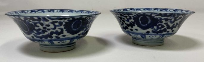 A pair of 19th century Chinese blue and white bowls with painted marks to the base, diameter 17cm.