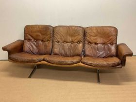 WERNER LANGENFELD FOR ESA; a leather three seater sofa, height 80cm, width 220cm, depth 70cm.