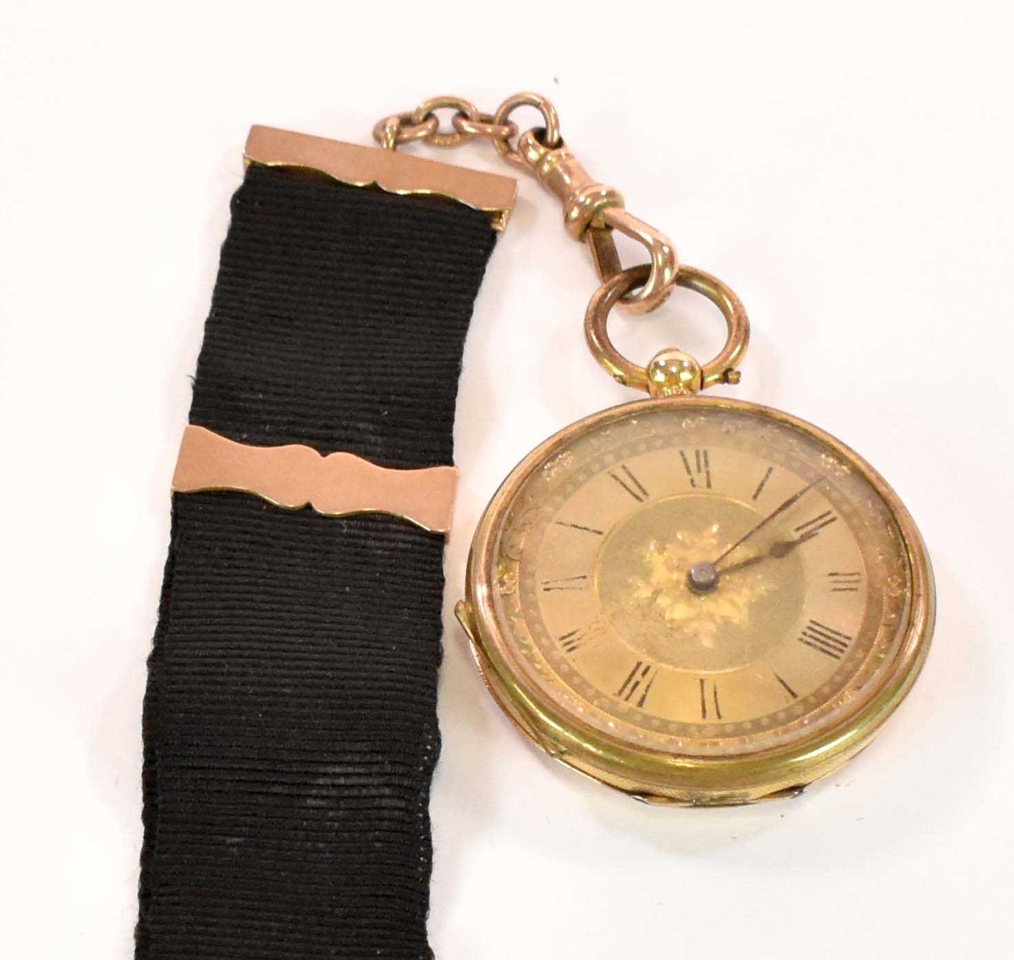 An 18ct yellow gold key wind open face fob watch with Roman numerals to the dial, and with base