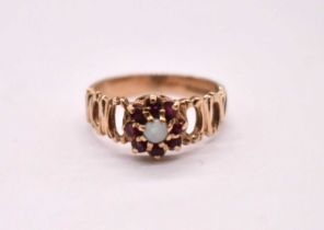 A 9ct yellow gold opal and garnet ring with pierced shoulders, size K, approx. 2.3g.