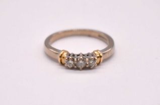 An 18ct yellow gold three stone diamond ring, the diamonds totalling approx. 0.25cts, size M 1/2,