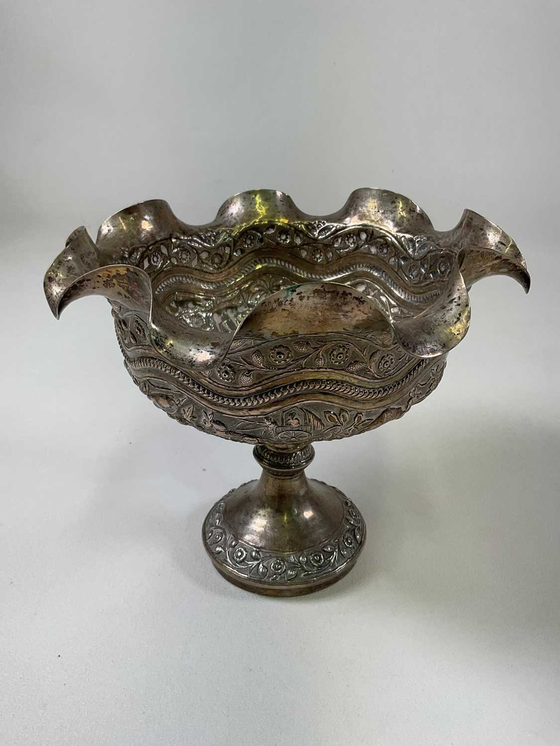 A large Indian silver embossed pedestal bowl with shaped rim, height 18cm, diameter 21cm, approx