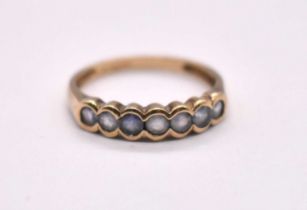 A 9ct yellow gold seven stone ring, size R 1/2, approx. 2.22g.