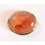 A 9ct yellow gold carnelian oval brooch, width 33mm, approx. 9.4g.