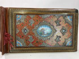 A well detailed Persian photograph album with white metal and enamelled detail to the cover, painted