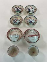A quantity of 18th and 19th century tea bowls and saucers, decorated with floral designs in an