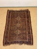 A vintage woven Persian rug, 182cm x 123cm.