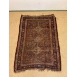 A vintage woven Persian rug, 182cm x 123cm.