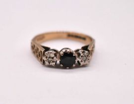 A 9ct yellow gold sapphire and diamond illusion set three stone ring with textured detail to the
