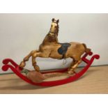 A rare side facing pine sleigh rocking horse, the front leg raised upon a carved pheasant and with