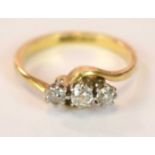 An 18ct yellow gold platinum tipped three stone diamond ring in swept setting, size J, approx. 3g.