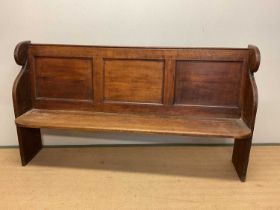 A 19th century oak panelled back church pew with scrolled sides, height 105cm, width 188cm, depth