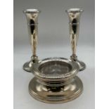 A pair of George V hallmarked silver candlesticks raised on spreading circular bases, Birmingham