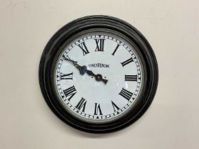 SYNCHRONOME; a metal and glazed wall clock with enamel dial, set with Roman numerals, diameter