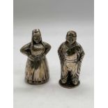 Two Dutch white metal figural pepperettes, one with partial mark, heights approx 8cm, combined