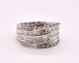 A 14ct white gold diamond cluster ring, set with three rows of baguette cut stones and four rows