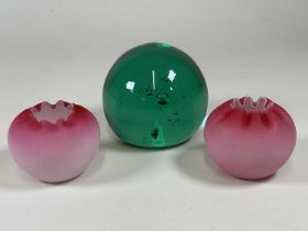 A large Victorian green glass dump weight, with a pair of pink tinted vases with crimped rims (3)