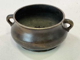 A late 19th century Chinese bronze censer with spurious Yongsheng mark to base and with twin lug