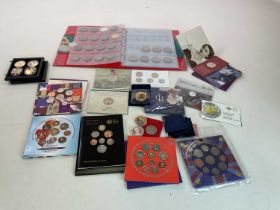 A quantity of coins, including several commemorative packs, also a 1999 Guernsey £5 gold coin (1/