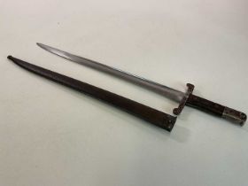 A British Victorian bayonet with scabbard, markings to the blade, and hilt, belt housing mount