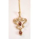 A 9ct yellow gold seed pearl set pendant in the Art Nouveau manner suspended on a fine link chain,