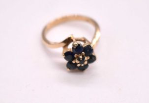 A 9ct yellow gold synthetic sapphire floral ring, size L, approx. 3.1g.