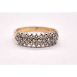 An 18ct yellow gold platinum tipped diamond ring set with three rows of round brilliant cut