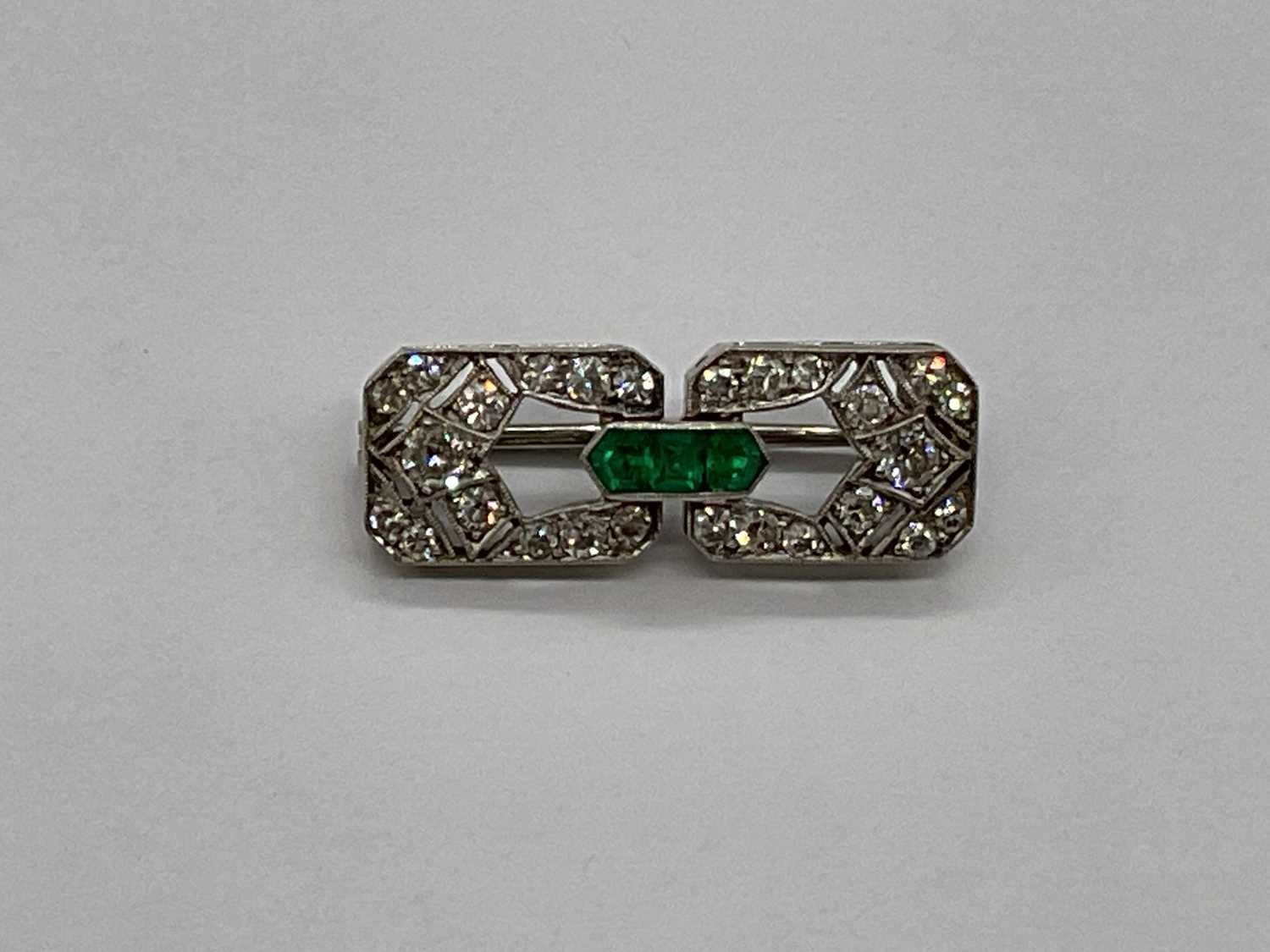 An Art Deco white metal emerald and diamond brooch set with three emeralds to the central raised - Image 4 of 6