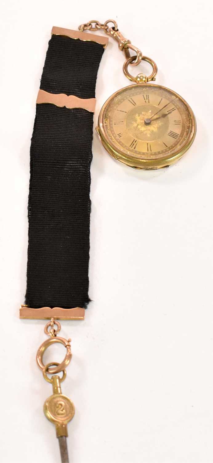 An 18ct yellow gold key wind open face fob watch with Roman numerals to the dial, and with base - Image 2 of 2