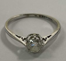 An 18ct white gold diamond solitaire ring, the eight claw set round brilliant cut stone weighing