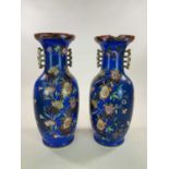 A very large pair of mid 19th century blue ground vases in the Chinoiserie style with stylised