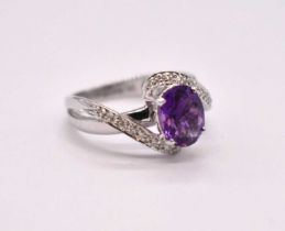 A 9ct white gold amethyst dress ring in swept crossover setting, size O, approx. 3.14g.