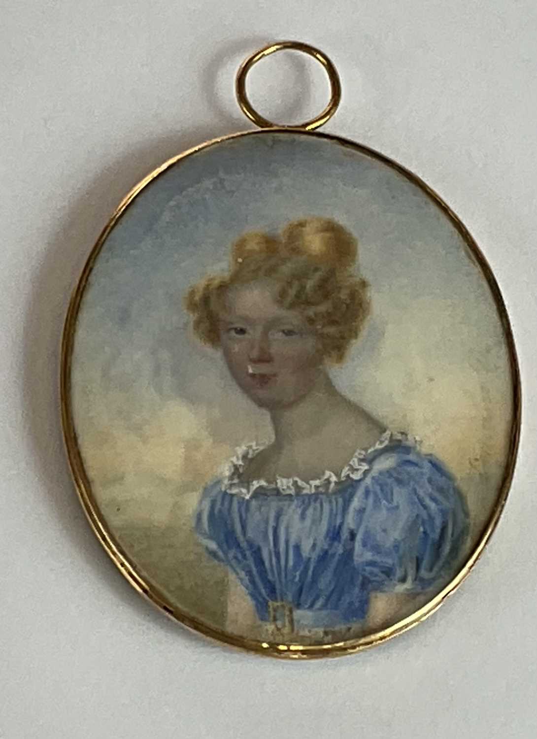 X A late 19th century oval portrait miniature, young woman wearing blue dress with plaited hair