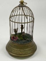 An early 20th century three bird automaton singing musical birdcage with scroll detail to the frame,