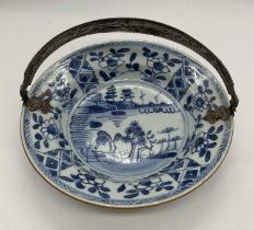 An 18th century Chinese blue and white bowl with white metal hinged, later applied, handle, diameter