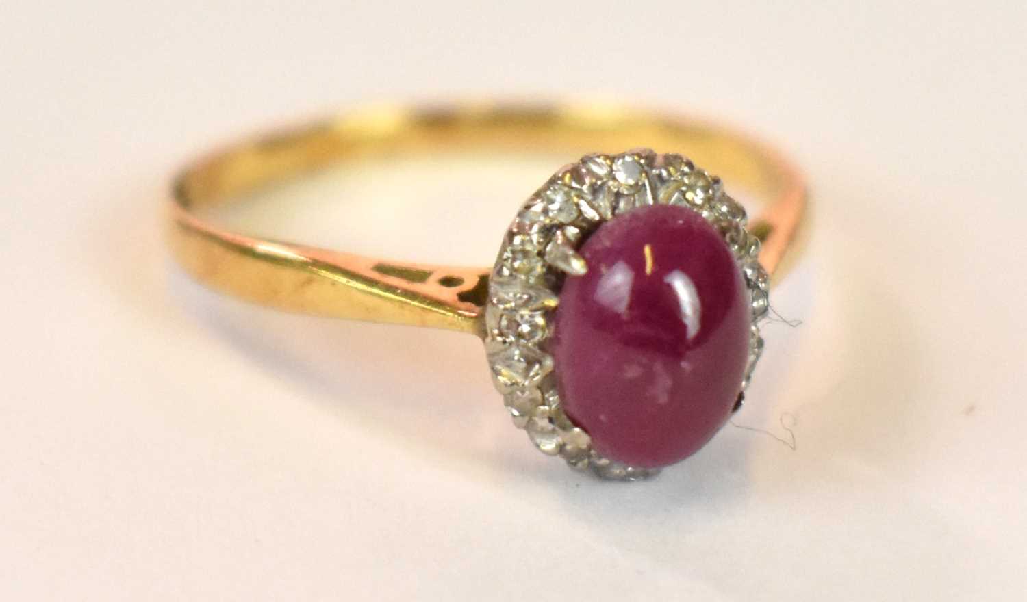 An 18ct yellow gold platinum tipped star ruby and diamond chip ring, size M 1/2, approx. 2.7g.