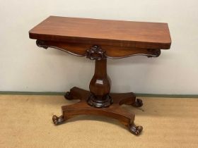 A 19th century mahogany folding card table with a circular baize centre with a single column on four