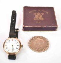 A vintage 9ct gold cased wristwatch head with Roman numerals to the white enamel dial, and a