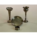 A small Elizabeth II hallmarked silver wine coaster, two hallmarked silver bud vases, both loaded, a